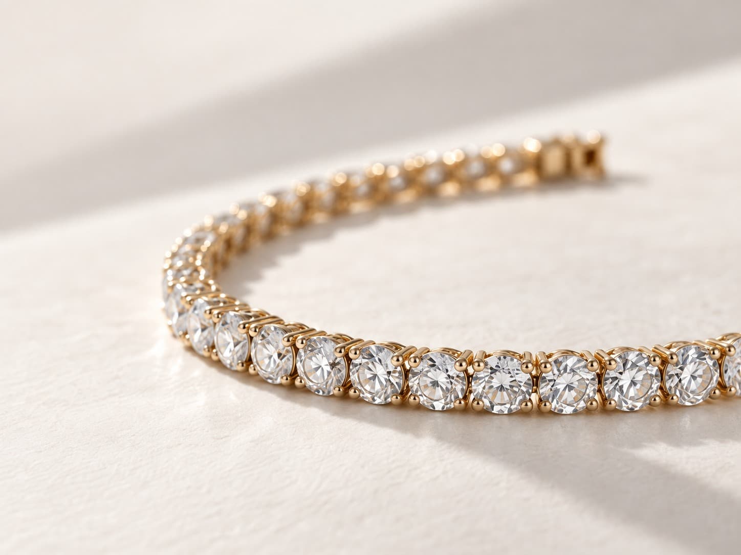 Gold chain bracelets arranged on linen